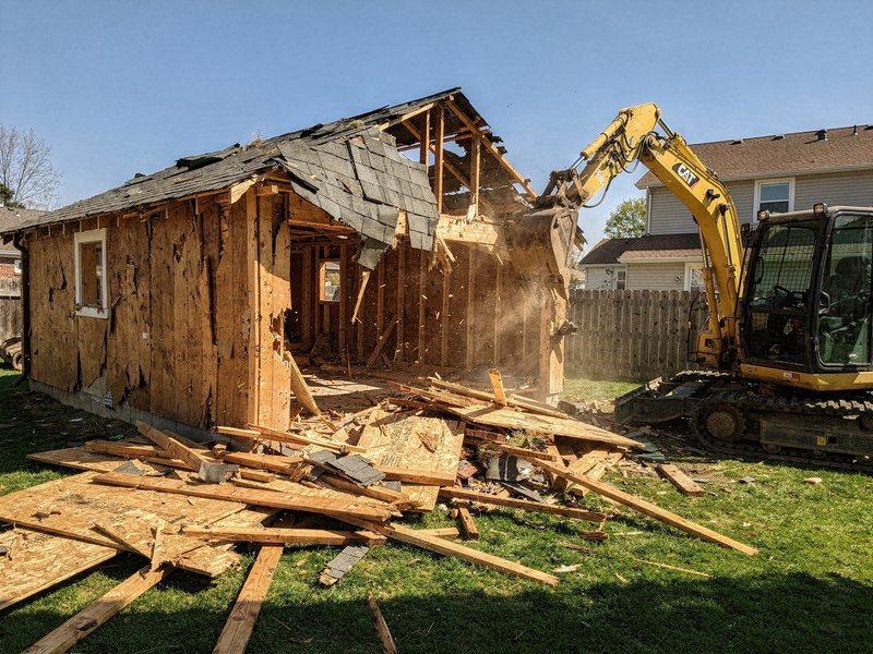 Detached garage teardown by excavator in Houston, TX